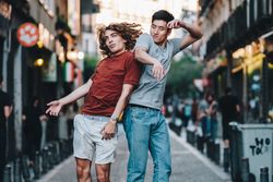 Courageous multiethnic male friends jumping and having fun on street