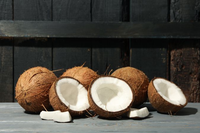 Coconut on wooden background, space for text. Tropical fruit