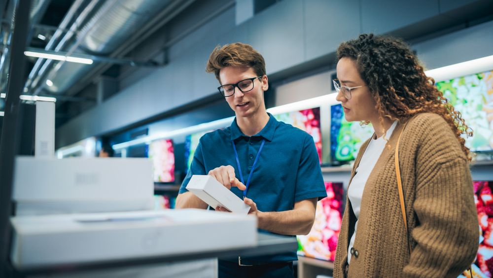 Portrait of a Female Customer Seeking Advice from Retail Home Electronics Expert.