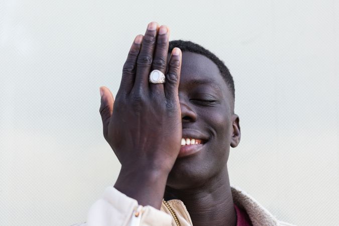 Stylish Black man covering face