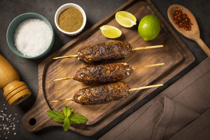 Beef kafta on the wooden board. Kafta, Traditional Arabic cuisine.