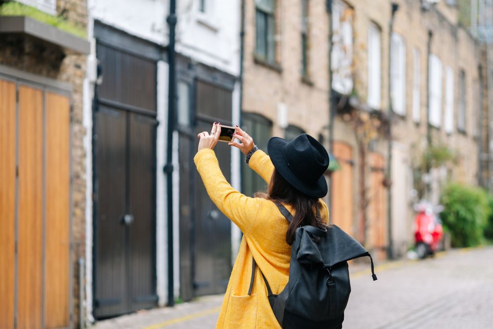 Anonymous traveler taking picture of building