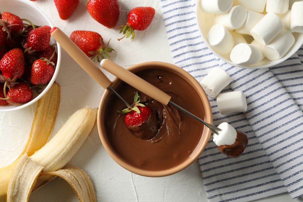Composition with strawberry and marshmallow in chocolate, top view. Chocolate fondue