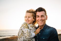 Father with her daughter at beach