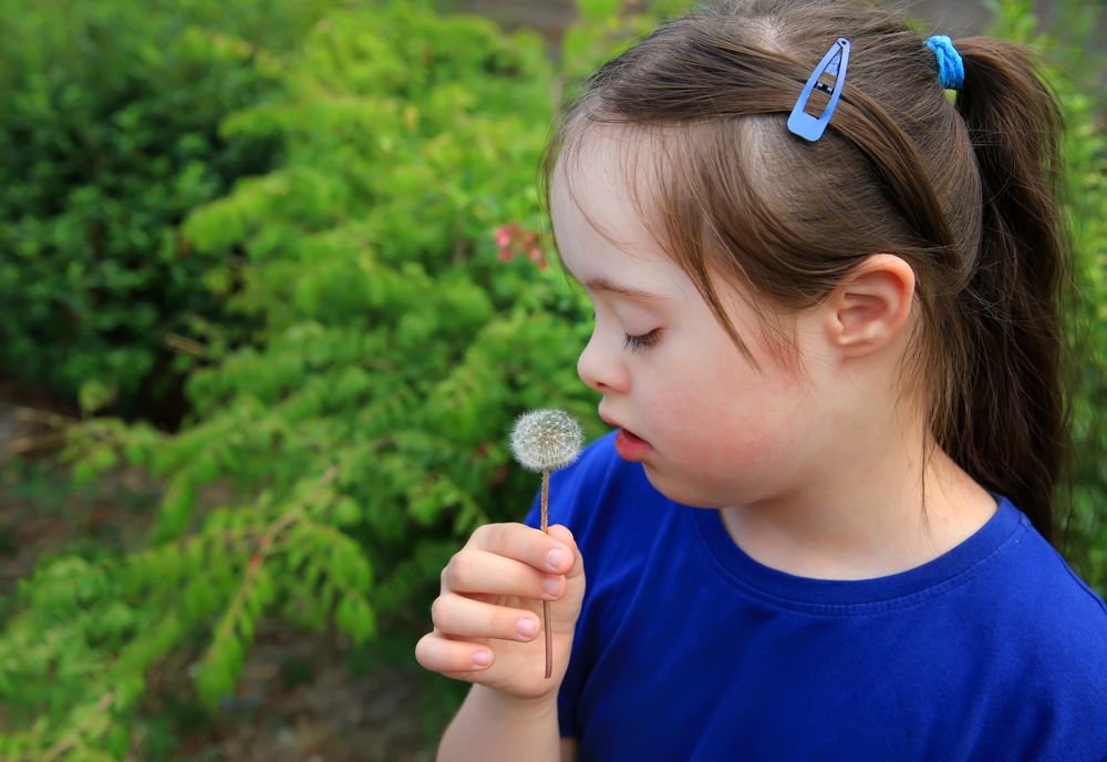 Side view of a child thinking of wish she’s going to make