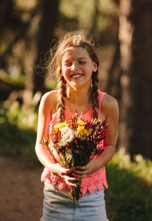 Happy girl with a bouquet of flowers in hand