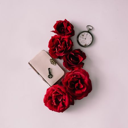Red roses with book, key and watch