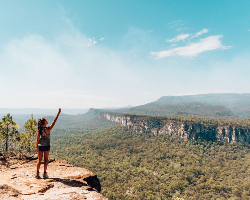 Woman in sports outfit standing on rock