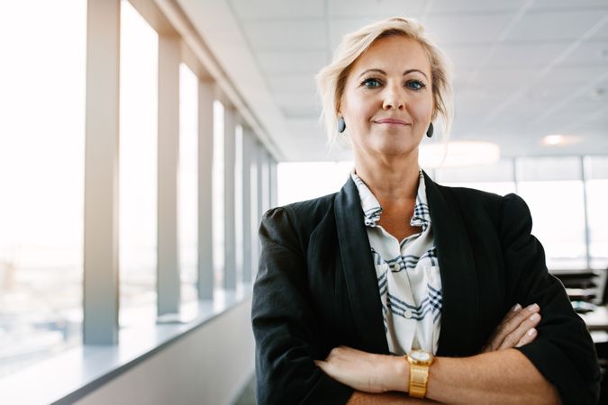 Confident mature businesswoman standing in office