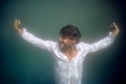Man drowning in deep blue water