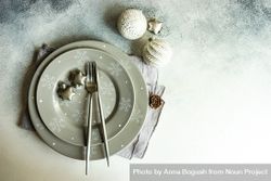 Festive Christmas table setting with baubles and snowflake plate 5R9LJ0