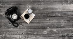 Old wooden desk table with retro business things