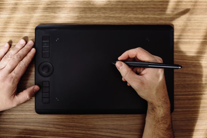Person drawing on tablet