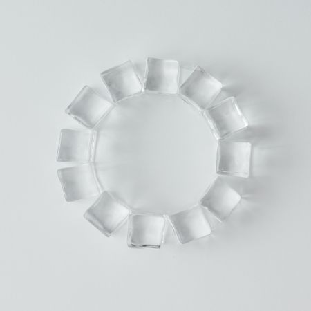 Ice cubes in circle on bright background