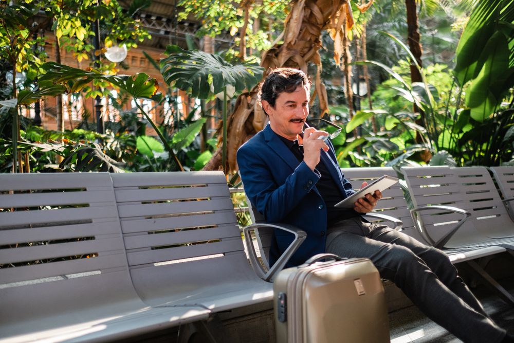 Older handsome man using digital tablet outdoors