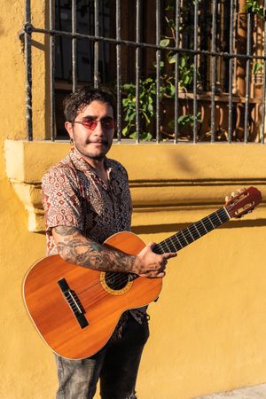 Young Musician With Acoustic Guitar Outdoors On The Street
