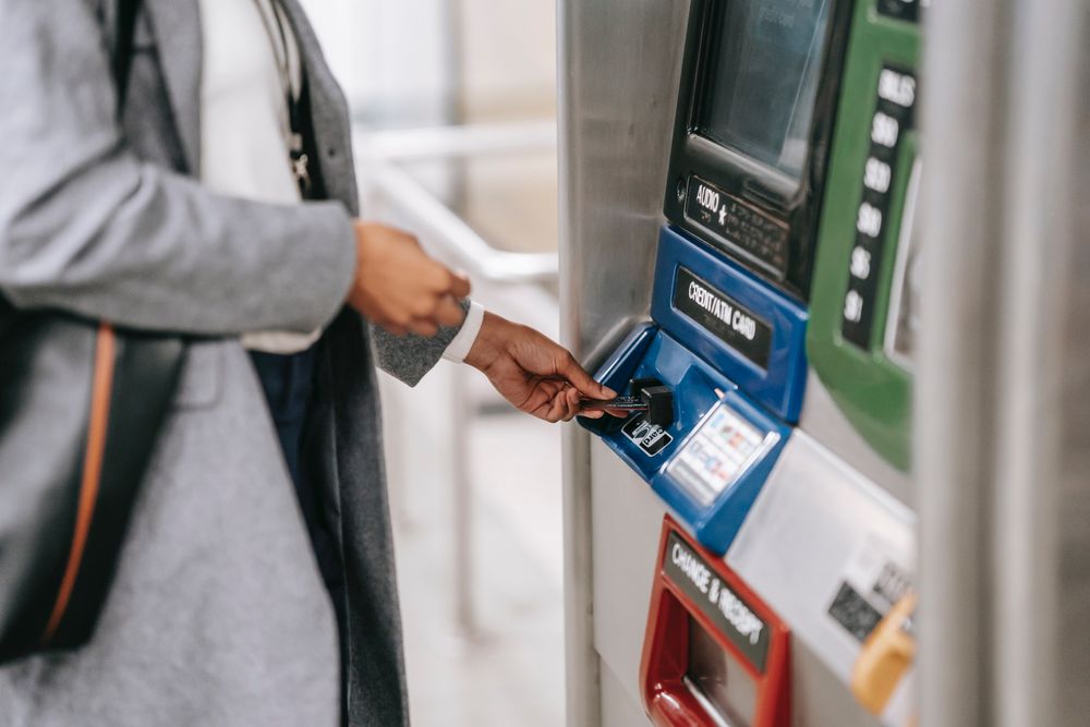 Cropped image of person using ATM