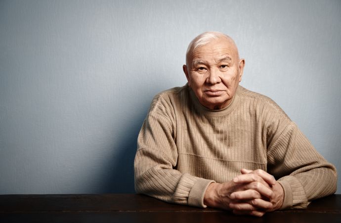 Pensive older man sitting at the table