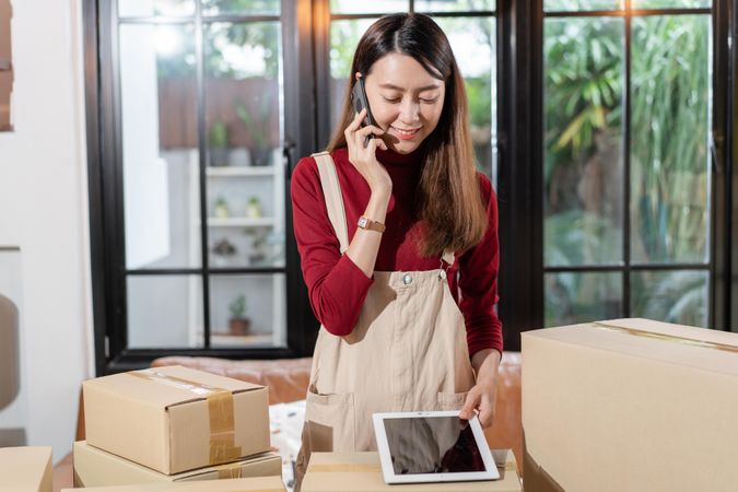 Female e-commerce business owner on her phone