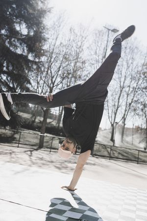 Man dancing break dance in park