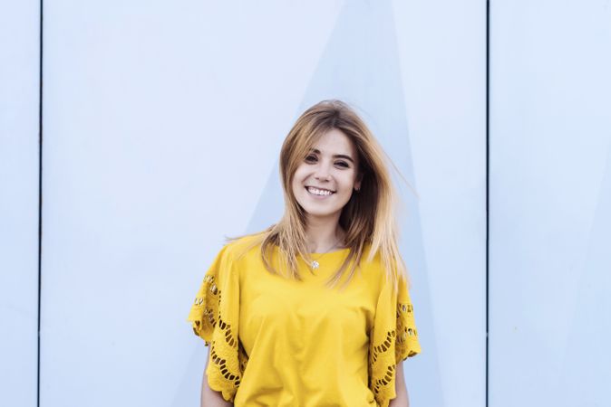 Young woman standing on blank background