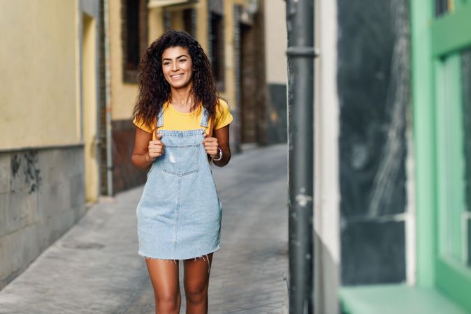 Arab woman walking in the street in denim dress