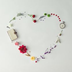 Layout with colorful flowers, leaves and heart shape