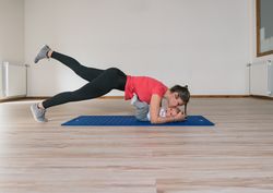Mother exercising and kissing baby
