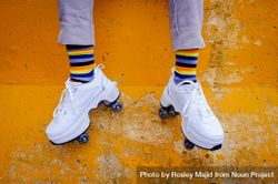 Unrecognizable person wearing sneakers with wheels and rainbow socks 5wVm10