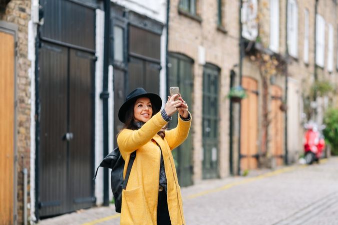 Woman taking picture of building