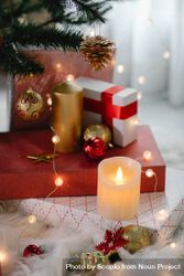 Gift boxes and candle under Christmas tree 0gq834