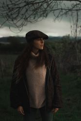 Young woman in warm clothes in forest