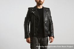 Man in dark leather biker jacket on light background be1Rlb