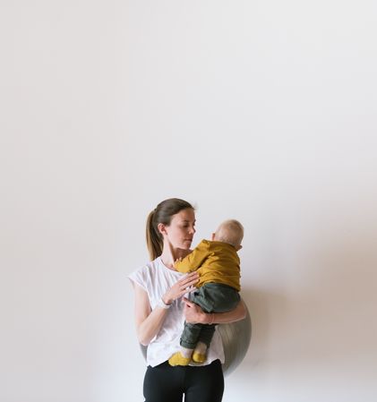 Woman holding baby in gym