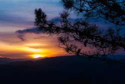 Cloudy sunset sky over hills