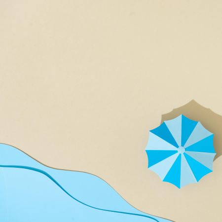 Paper beach with umbrella and sea