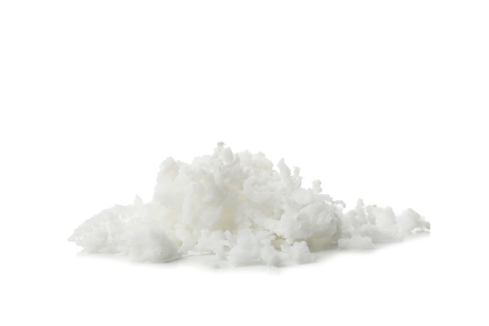 Coconut flakes isolated on light background. Tropical fruit