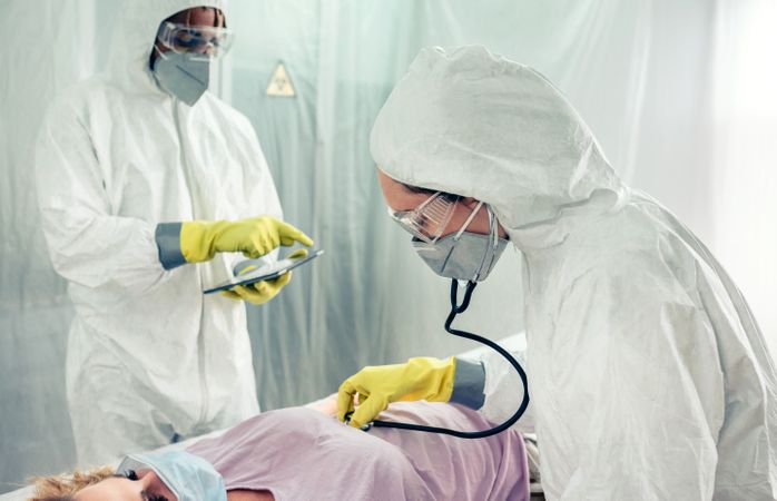 Doctors in a field hospital examining a patient