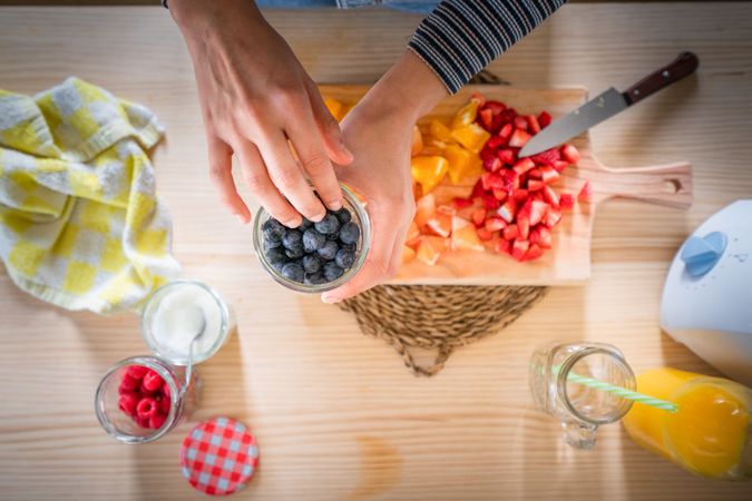 Crop woman preparing healthy food