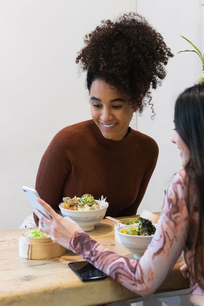 Smiling multiethnic women eating in restaurant