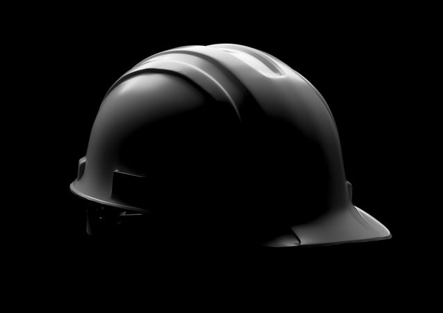 Dramatically Lit Hard Hat Isolated on a Dark Background.