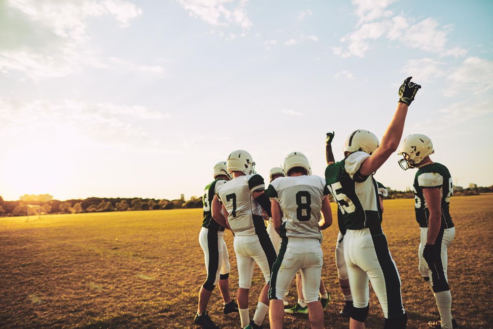 Football players standing together before practice