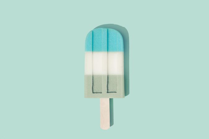 Colorful ice cream popsicle on pastel blue background