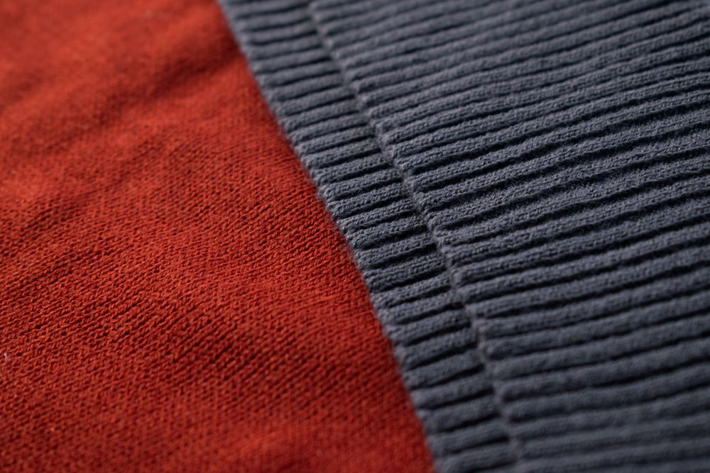 Close up dark grey knitted fabric background texture.