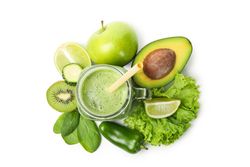 Green vegetables, fruits and jar of smoothie isolated on blank background