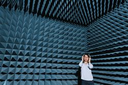 Woman in sound room listening to music