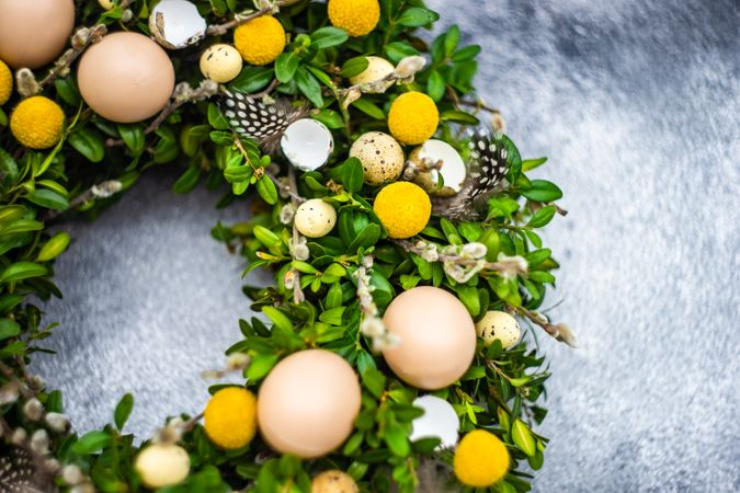 Easter card concept with wreath with decorative eggs and branches