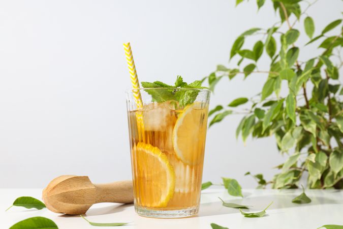 A glass of cold tea with fresh orange slices