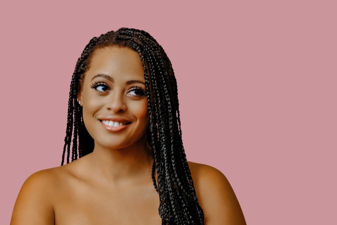 Studio portrait of female with braided hair and copy space