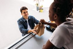 Male buying takeaway food from vendor